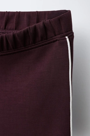 Расклешенные брюки из модала с контрастной отделкой- Заказать в России