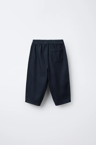 Брюки из мягкой ткани с пуговицами- Заказать в России