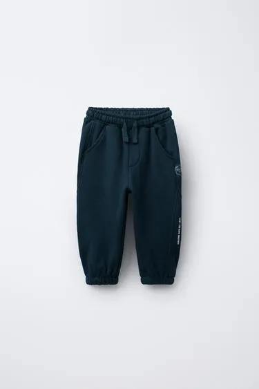 Трикотажные брюки-джоггеры с надписью- Заказать в России