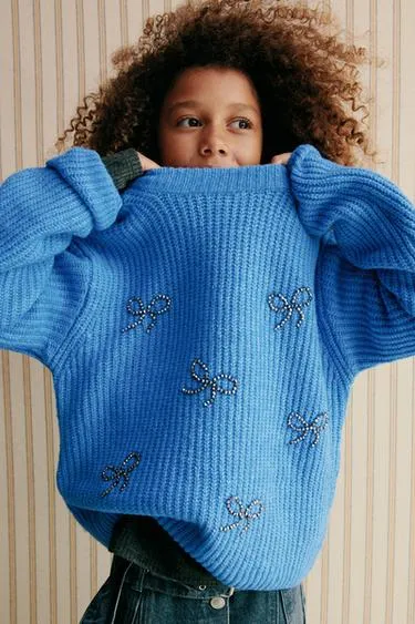 Трикотажный джемпер с бусинами, бантами и блестками- Заказать в России