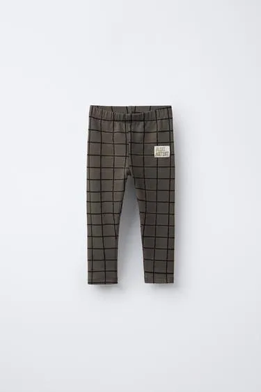 Брюки-леггинсы в клетку с деталями бренда