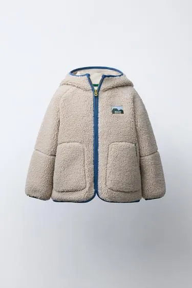 Куртка из искусственного меха с контрастными отделками- Заказать в России