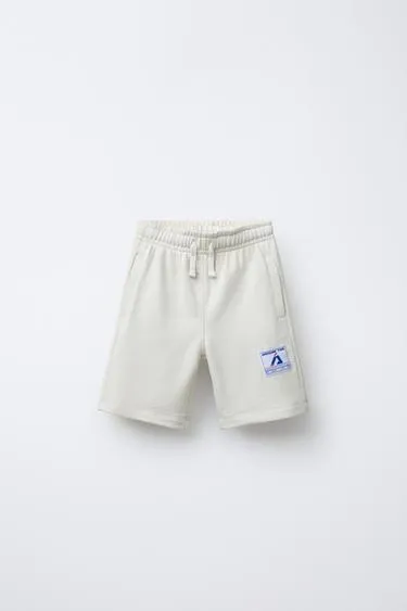 Шорты-джоггеры с нашивками- Заказать в России