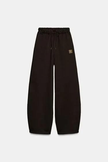 Брюки из мягкой ткани с нашивкой- Заказать в России