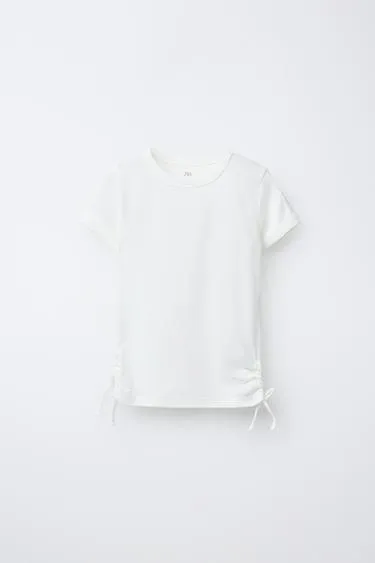 Футболка из модала с вырезами и бантами