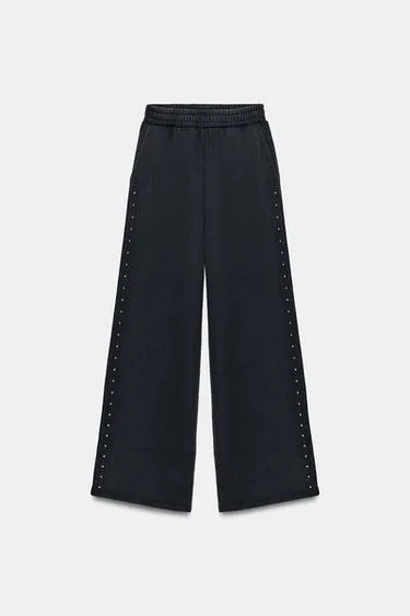 Брюки из мягкой ткани с эффектом потертости и заклепками