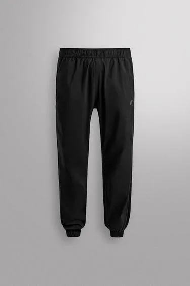 Брюки-джоггеры из высокотехнологичной ткани- Заказать в России