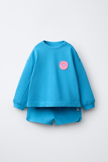 Комплект из толстовки и шорт с резиновым цветком- Заказать в России