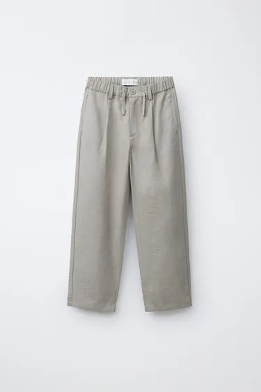 Брюки свободного кроя с защипами