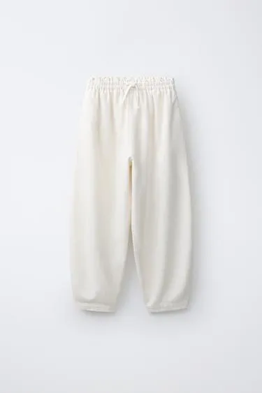 Шаровые брюки с эластичным поясом и аппликацией-шнурком спереди- Заказать в России