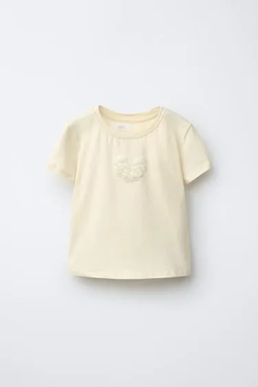 Футболка с бантом и бусинами- Заказать в России