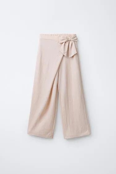 Широкие брюки в полоску с блестками и бантом