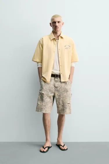 Шорты  с абстрактным принтом и эффектом потертости