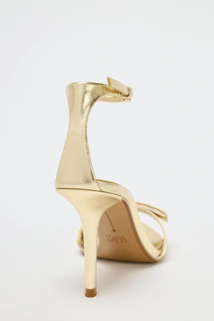 Босоножки с металлическим блеском с бантом и высоким каблуком- Заказать в России