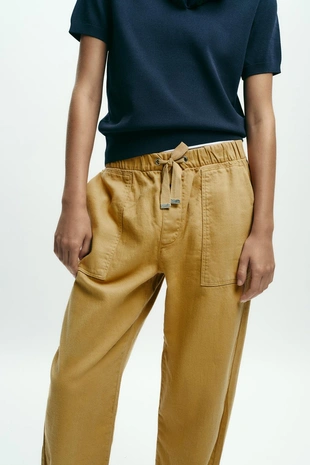 Брюки-джоггеры с застежкой на кнопку снизу- Заказать в России