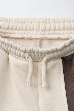 Брюки-джоггеры в стиле колор-блок с нашивкой- Заказать в России