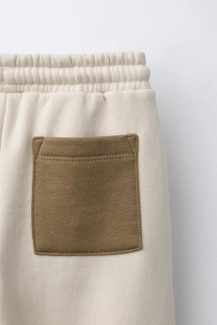 Брюки-джоггеры в стиле колор-блок с нашивкой- Заказать в России