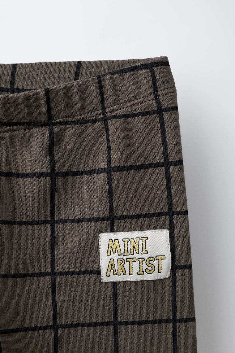 Брюки-леггинсы в клетку с деталями бренда