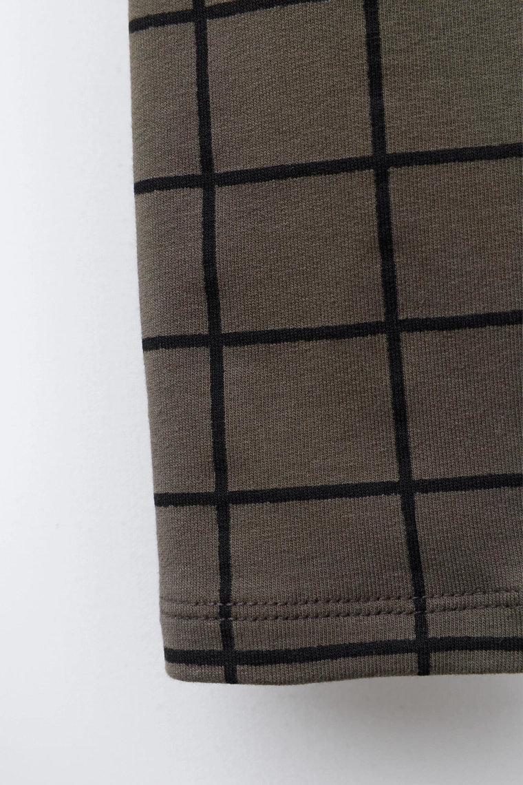 Брюки-леггинсы в клетку с деталями бренда