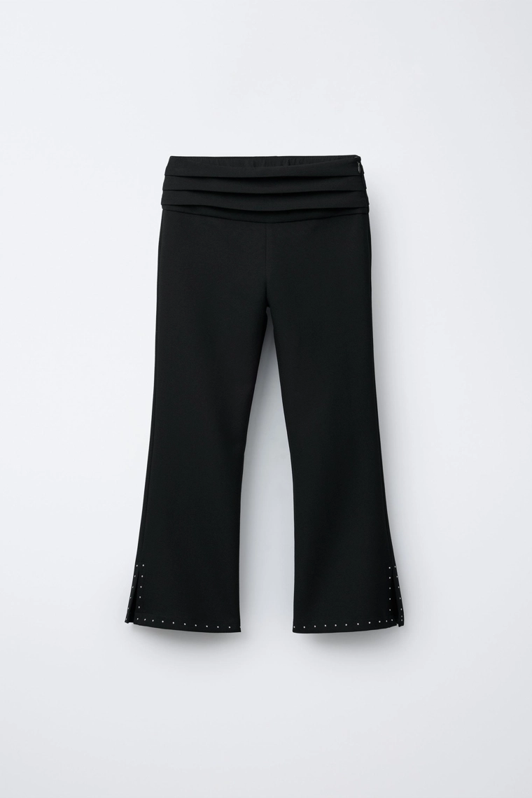 Зауженные брюки с заклепками