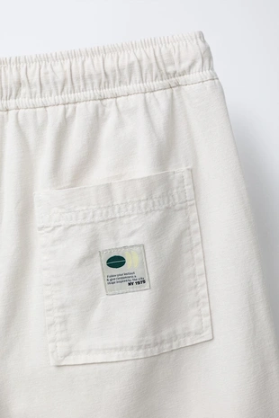 Шорты хлопковые с нашивкой- Заказать в России