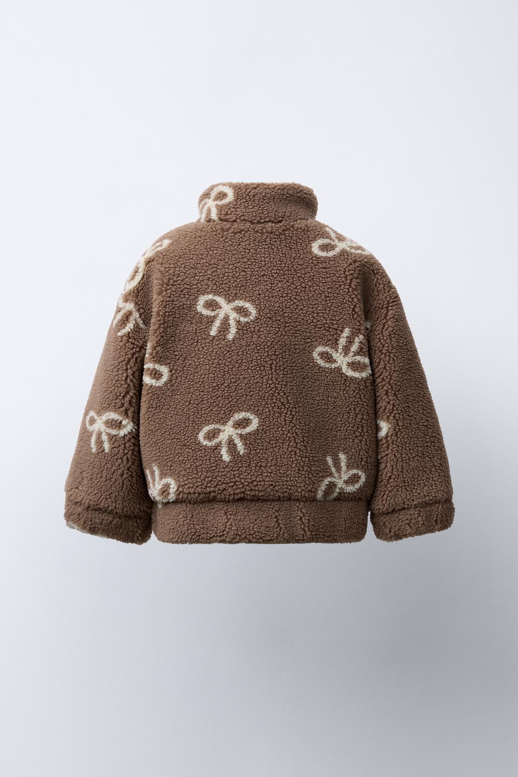 КУРТКА ИЗ ИСКУССТВЕННОЙ ОВЧИНЫ С БАНТАМИ