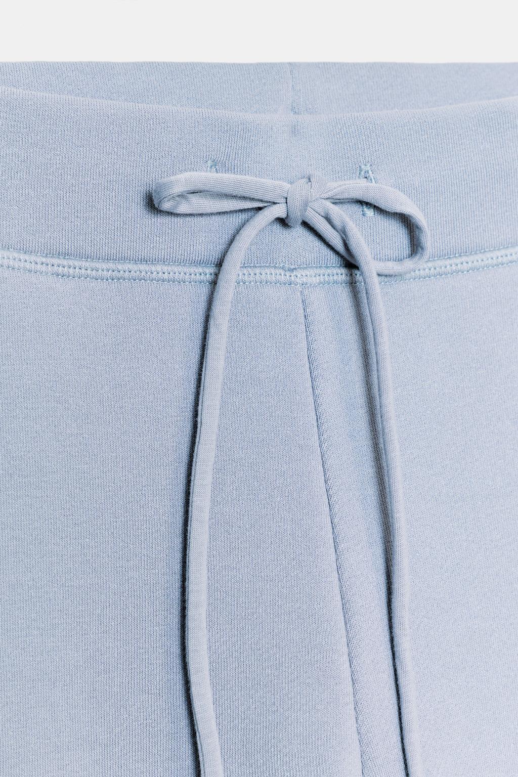 РАСКЛЕШЕННЫЕ БРЮКИ С ЭФФЕКТОМ ПОТЕРТОСТИ