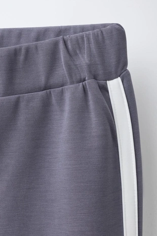 Расклешенные брюки из модала с контрастными полосками- Заказать в России