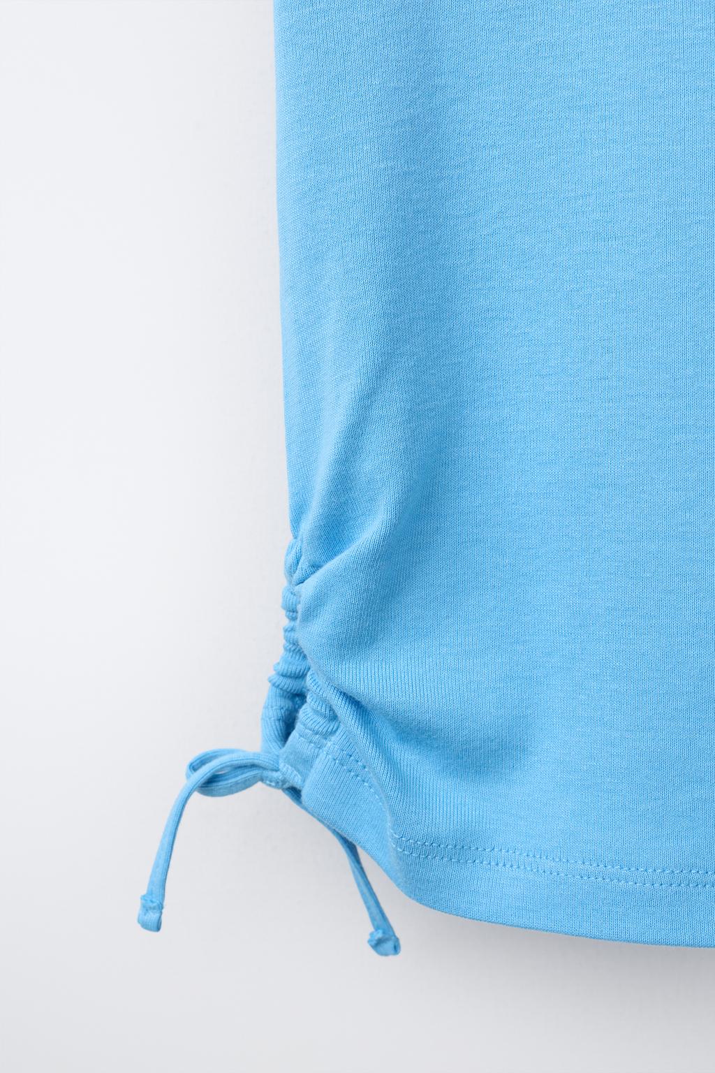 ФУТБОЛКА ИЗ МОДАЛА С ВЫРЕЗАМИ И БАНТАМИ