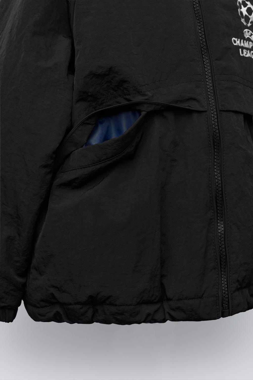 КУРТКА С ПОТАЙНЫМ КАПЮШОНОМ WATER REPELLENT UEFA CHAMPIONS LEAGUE ®