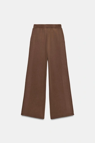 Брюки из мягкой ткани с эффектом потертости и заклепками- Заказать в России