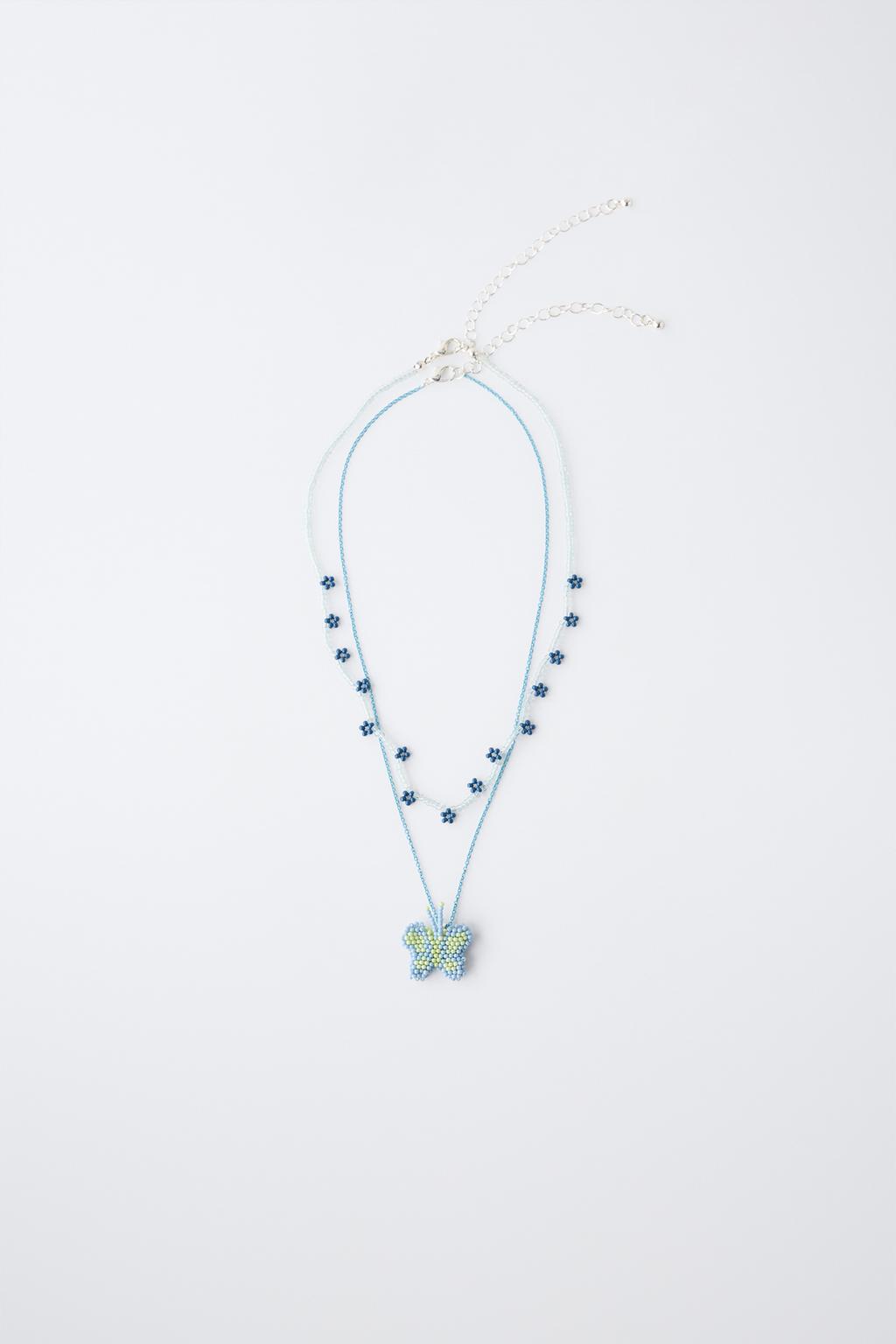 НАБОР ИЗ ДВУХ ОЖЕРЕЛИЙ С БУСИНАМИ, БАБОЧКОЙ И ЦВЕТАМИ