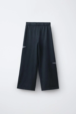 Брюки из мягкой ткани  с эффектом потертости и звездами- Заказать в России