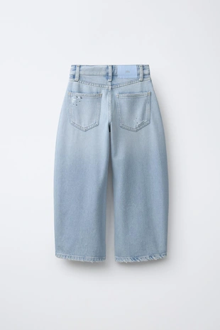 Джинсы баллон с рваными деталями и стразами- Заказать в России