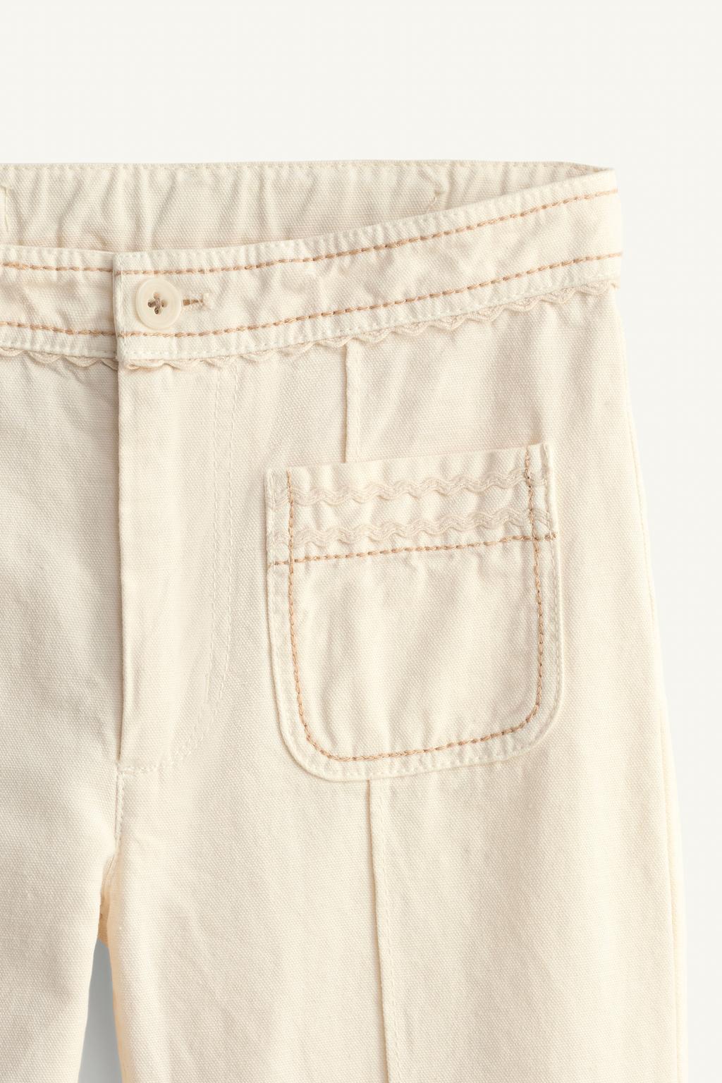 Брюки limited edition с расклешенными штанинами и контрастной строчкой