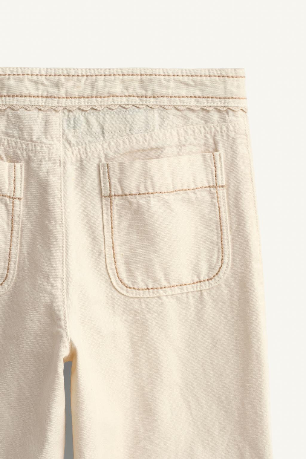 Брюки limited edition с расклешенными штанинами и контрастной строчкой