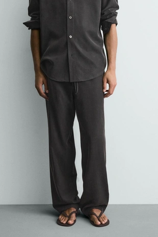 Струящиеся брюки Relaxed Fit- Заказать в России