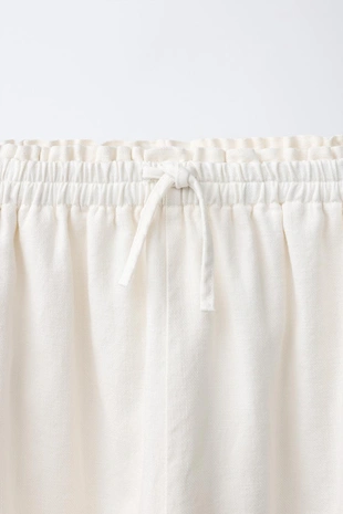 Шаровые брюки с эластичным поясом и аппликацией-шнурком спереди- Заказать в России