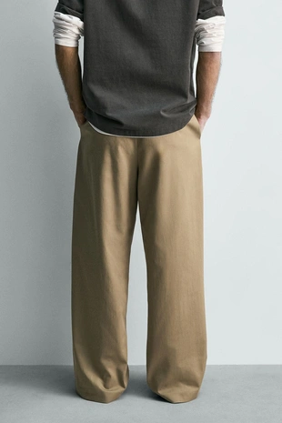 Свободные брюки с защипами и ремнем- Заказать в России