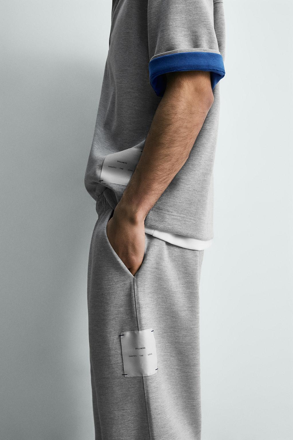 БРЮКИ С НАШИВКОЙ И ЭТИКЕТКОЙ