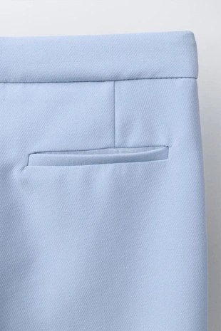 Костюмные брюки с декоративной пуговицей- Заказать в России