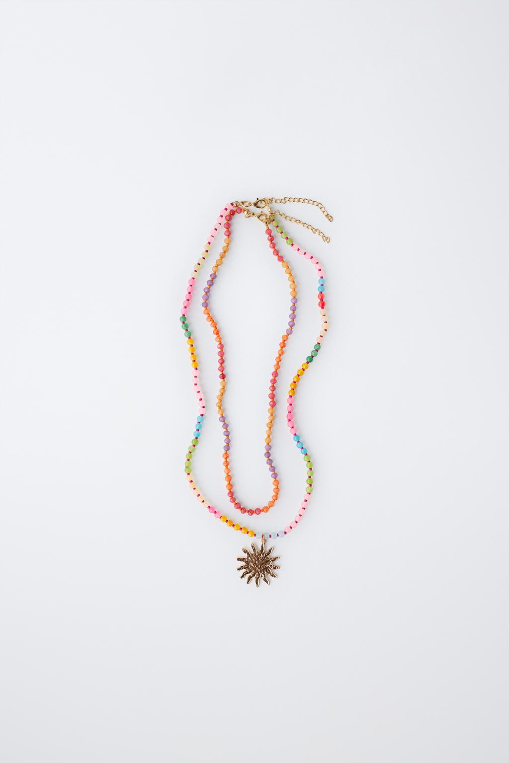 Набор из двух бус и колье с подвеской в виде солнца