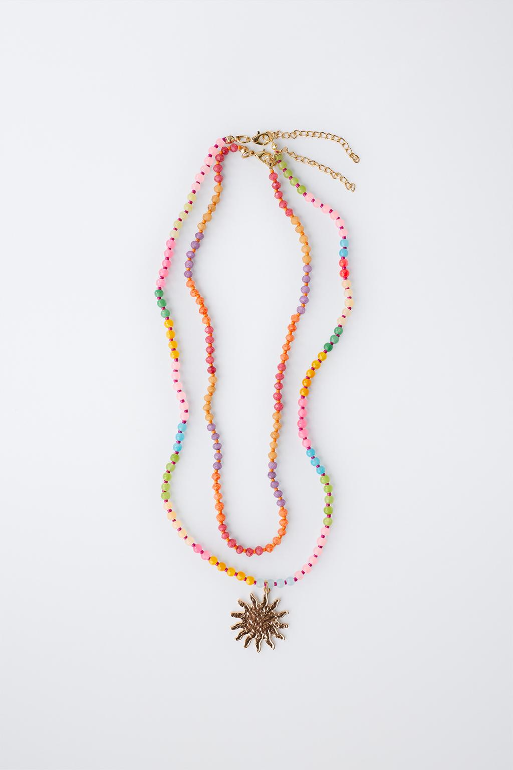 Набор из двух бус и колье с подвеской в виде солнца