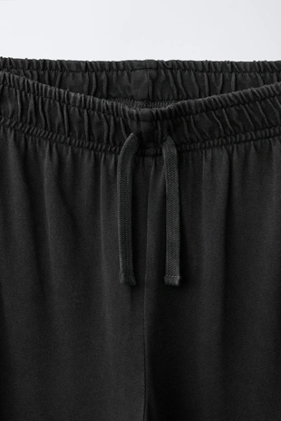 Брюки Wide Leg с эффектом потертости и принтом звезд- Заказать в России