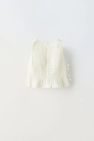 Топ с эластичной деталью и бантами- Заказать в России